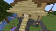 Stairs being used as a shade outside a small hut's door in Minecraft 1.19 (Image via Mojang)